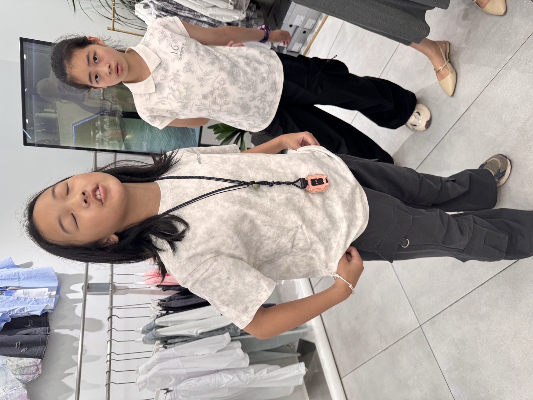 两名女孩在服装店或商场内合影